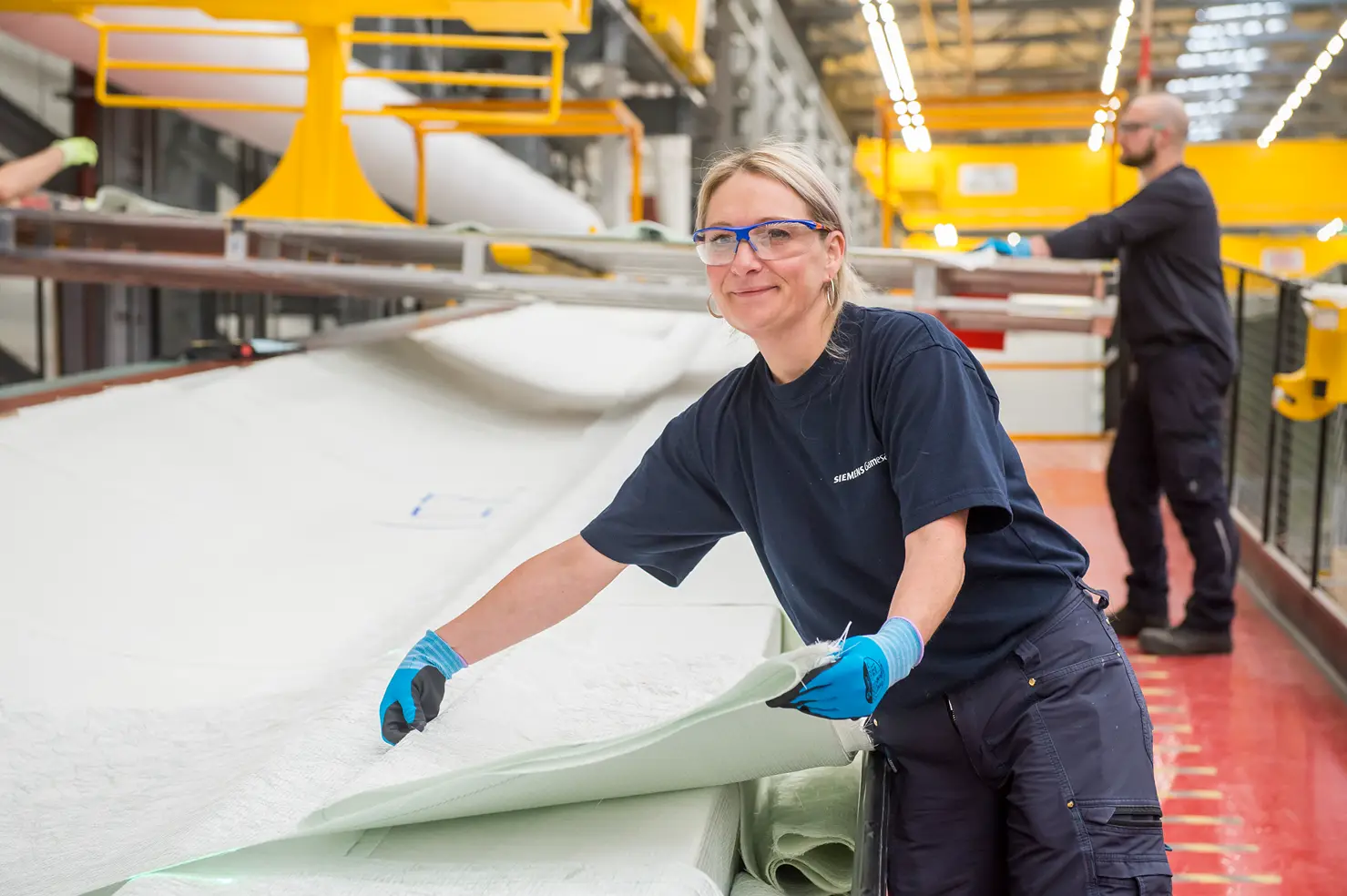 A woman making an offshore wind turbine blade at Siemens Gamesa Hull blade factory